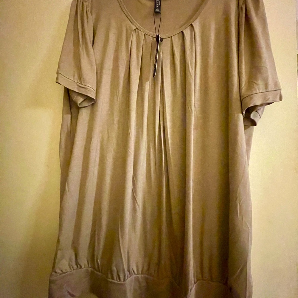 Brand new. Never worn.. Beige casual top.